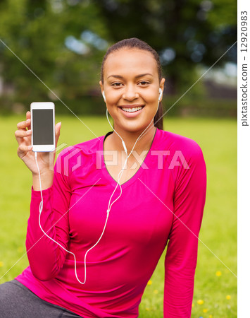 smiling african american woman with smartphone 12920983