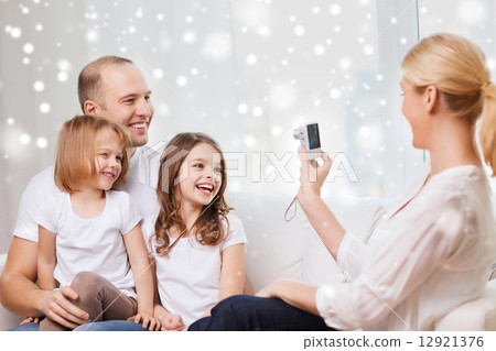 happy family with camera taking picture at home 12921376