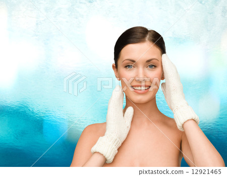 smiling young woman in white mittens 12921465