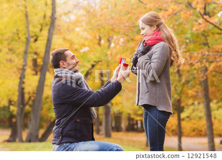 smiling couple with engagement ring in gift box 12921548
