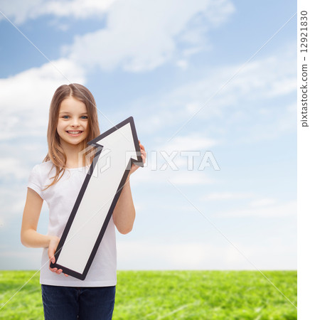 smiling little girl with blank arrow pointing up smiling little girl with blank arrow pointing up 12921830