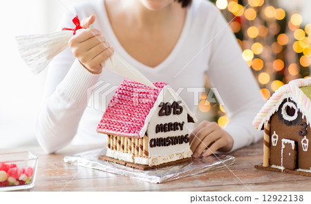 close up of woman making gingerbread houses 12922138