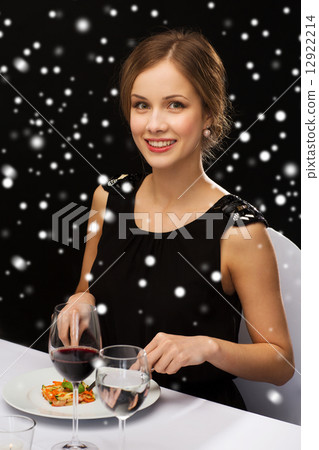 smiling woman with tablet pc eating main course smiling woman with tablet pc eating main course 12922214
