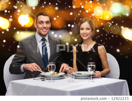 smiling couple eating main course at restaurant smiling couple eating main course at restaurant 12922215
