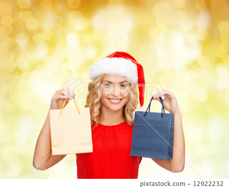woman in santa helper hat with shopping bags woman in santa helper hat with shopping bags 12922232