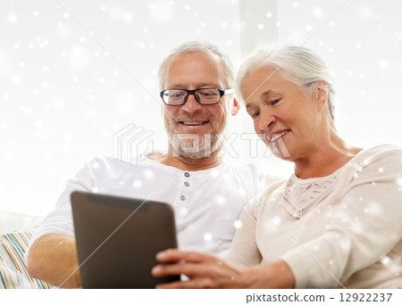happy senior couple with tablet pc at home happy senior couple with tablet pc at home 12922237