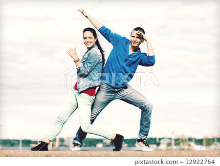 couple of teenagers dancing outside 12922764