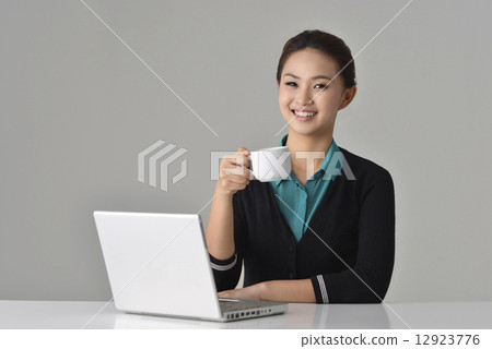 Asian Office Lady having a coffee break Asian Office Lady having a coffee break 12923776