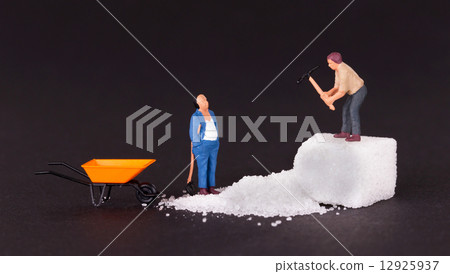Miniature worker working on a sugar cube Miniature worker working on a sugar cube 12925937