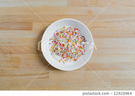 Sugar sprinkles in a bowl on wood 12928964