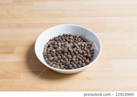 Allspice in a bowl on wood Allspice in a bowl on wood 12928969