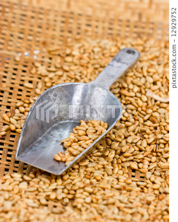 Fried sunflower seed with metal scoop in bamboo basket. Fried sunflower seed with metal scoop in bamboo basket. 12929752
