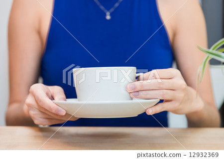 Holding a cup Holding a cup 12932369