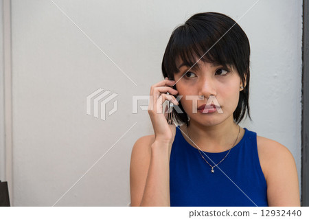 Woman speaking on the phone Woman speaking on the phone 12932440