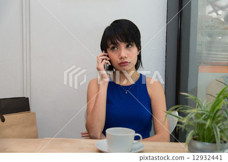 Woman speaking on the phone Woman speaking on the phone 12932441