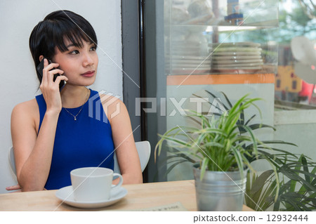 Woman speaking on the phone Woman speaking on the phone 12932444