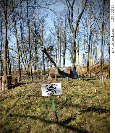 Land mine warning sign and barrel of a tank. Land mine warning sign and barrel of a tank. 12933252