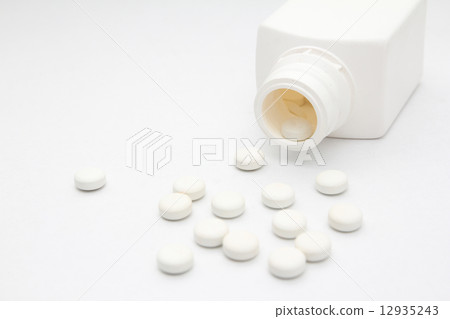 Bottle of white colored pills 12935243