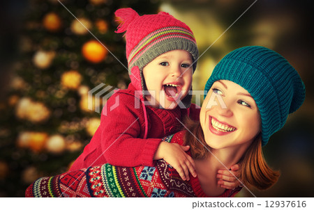 happy family mother and little daughter playing in the winter for Christmas