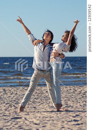 young couple dancing on a background of sea 12939542