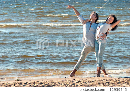 young couple dancing on a background of sea young couple dancing on a background of sea 12939543