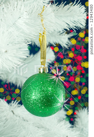 Green ball hanging on the Christmas tree 12943480