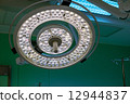 Surgical lamp in operation surgery room. Half brightness. 12944837