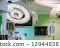 Surgical lamp in operation surgery room. Surgery monitors and IV solutions are on background. Green  12944838