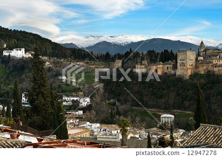 Alhambra and snowing Sierra Nevada mountains under a lenticular 12947278