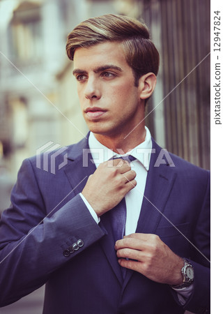 Attractive young businessman in urban background Attractive young businessman in urban background 12947824