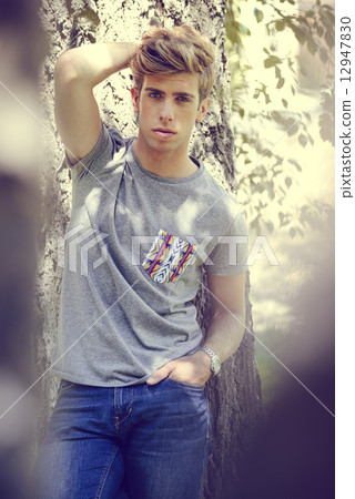 Attractive young handsome man, model of fashion in urban backgro 12947830