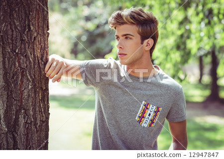 Attractive young handsome man, model of fashion in urban backgro 12947847