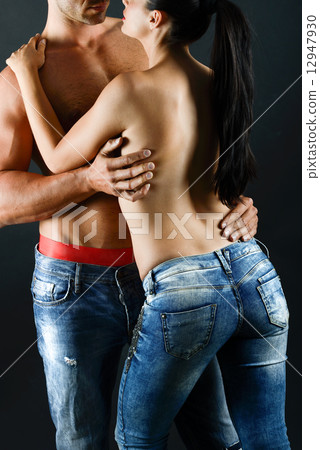 Sexy young couple with blue jeans standing together 12947930