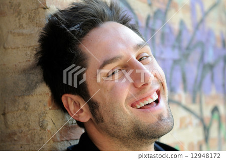 Portrait of happy man in urban background 12948172