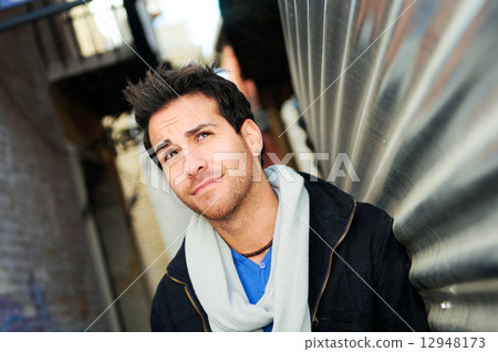 Portrait of handsome man in urban background 12948173