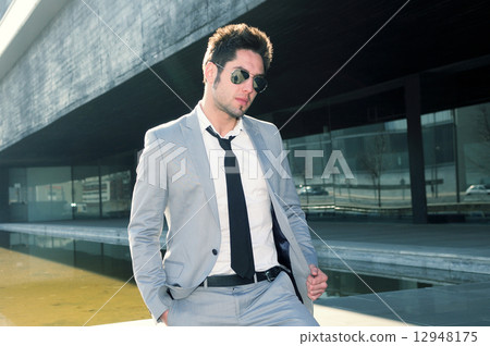 Portrait of a handsome young business man smiling 12948175