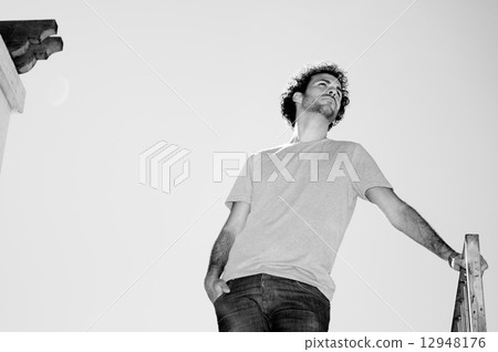 Man with curly hairstyle in the garden 12948176