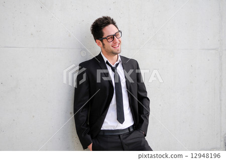 Portrait of a handsome young businessman smiling 12948196