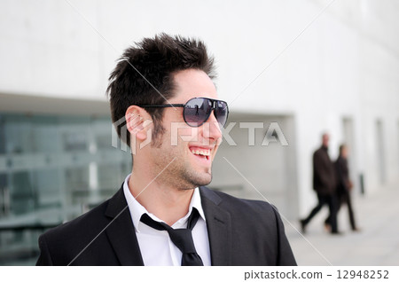Portrait of a handsome young business man smiling Portrait of a handsome young business man smiling 12948252