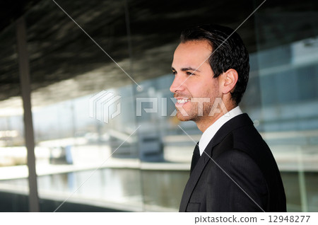 Portrait of a handsome young business man smiling 12948277