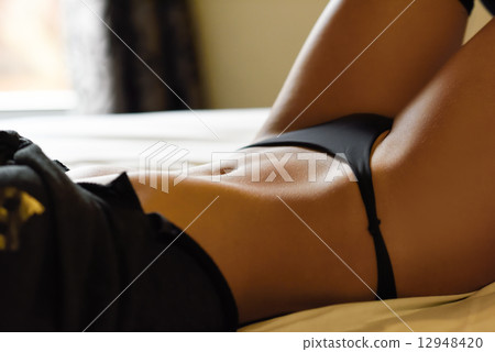 Sexy young woman in lingerie posing on the bed 12948420