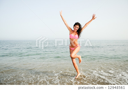 Woman with beautiful body on a tropical beach 12948561