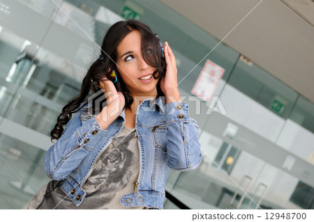 Young girl with headphones 12948700