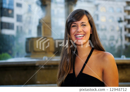 Attractive smiling woman portrait in urban background 12948712