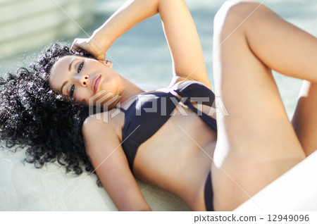 Young black woman, afro hairstyle, wearing bikini 12949096