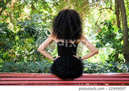 Young black woman, model of fashion in a garden 12949097
