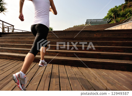 healthy lifestyle sports woman running on wooden stairs 12949387