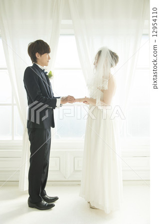 Bride and groom who exchanges rings 12954110