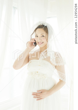 Talking on mobile phone, pregnant bride Talking on mobile phone, pregnant bride 12954294