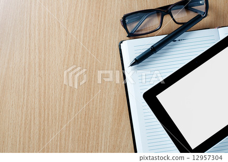 Modern tablet PC next to a classical open agenda Modern tablet PC next to a classical open agenda 12957304